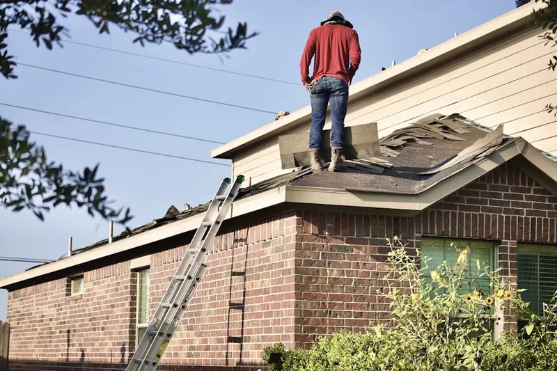 Professional roofer working on a residential roof in Downtown Pueblo